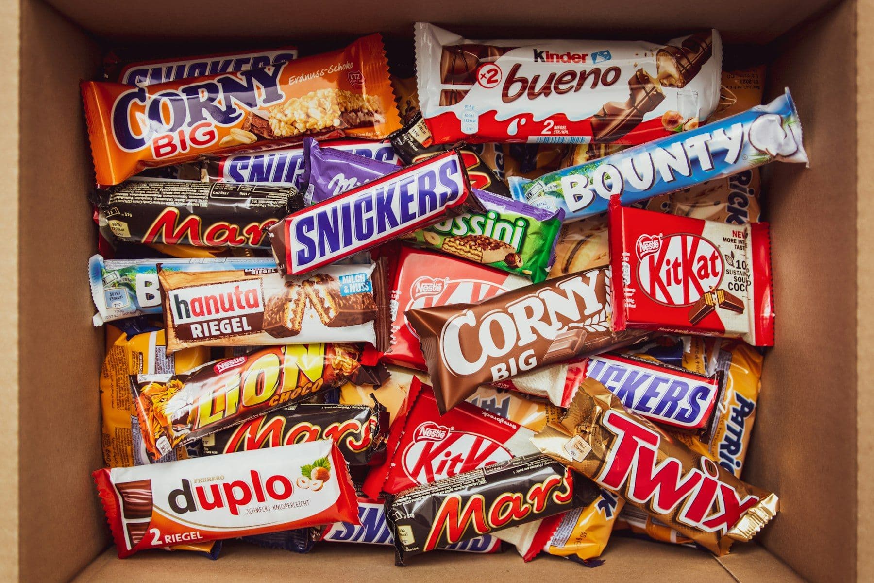 A cardboard case filled with assorted chocolate bars