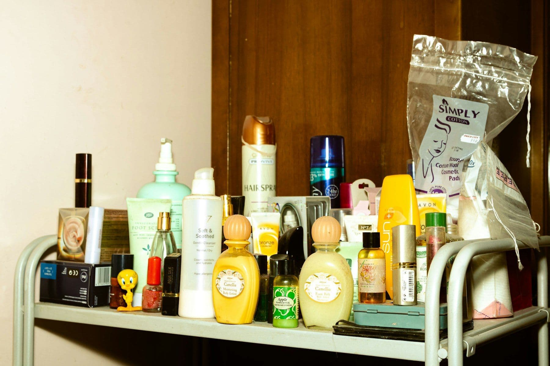 Shampoo, lotion and toiletry bottles on a bathroom trolley